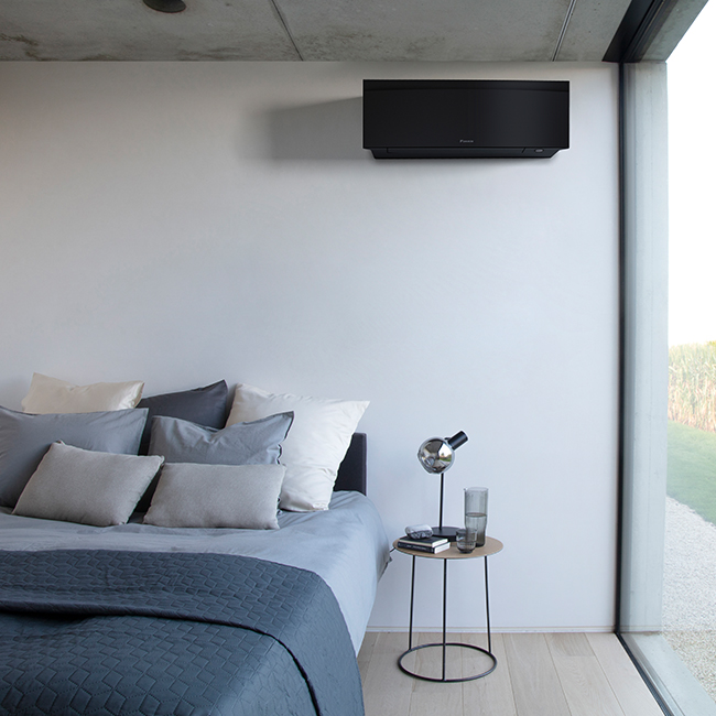 Daikin Emura Black indoor aircon unit placed in a bedroom